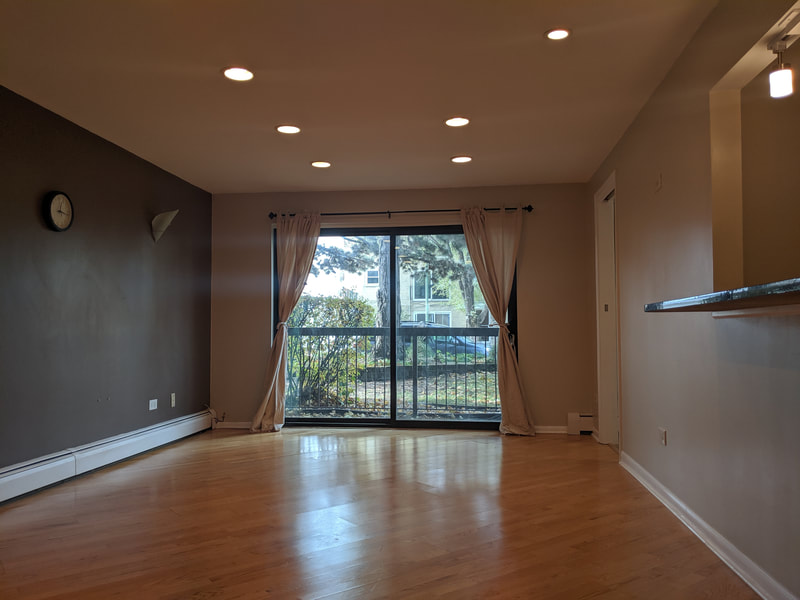 Living room, dimmed to show outside of balcony